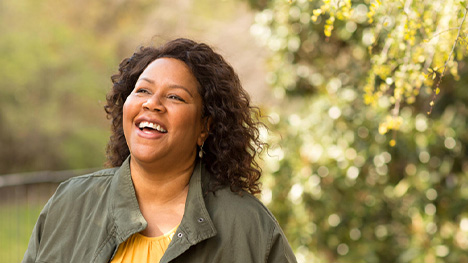 Person walking on a wooded path in sunshine