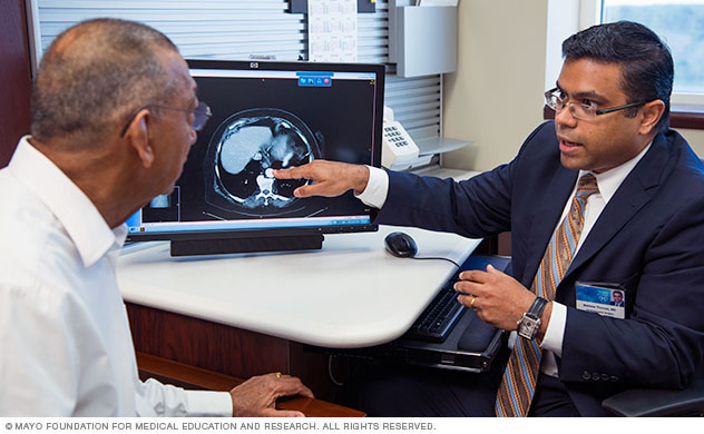 A doctor explains an esophagectomy procedure to a patient.