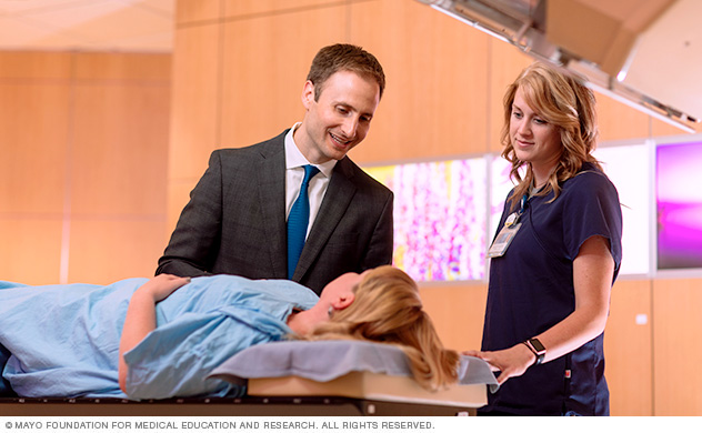 A doctor talking with a patient before radiation therapy