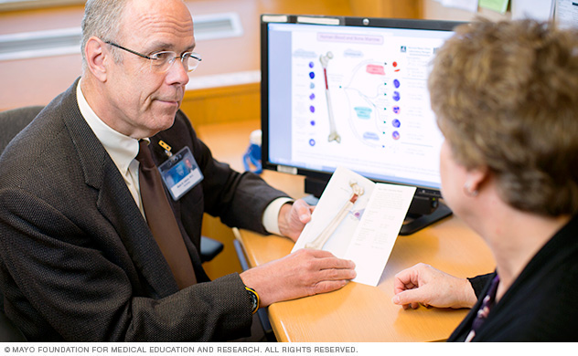 A Mayo Clinic physician talks with a woman about a possible ALL diagnosis.