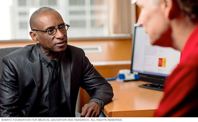 A Mayo Clinic physician talks with a man about a possible ALL diagnosis.