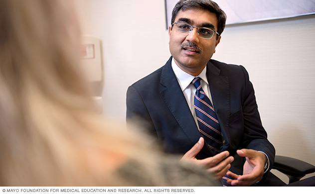 Photo shows a doctor talking to a patient