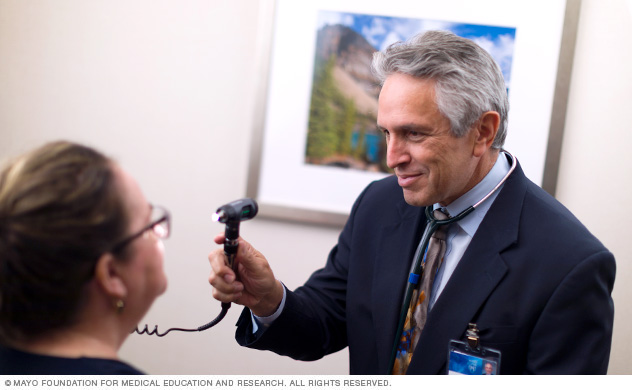 Photo shows doctor examining a patient