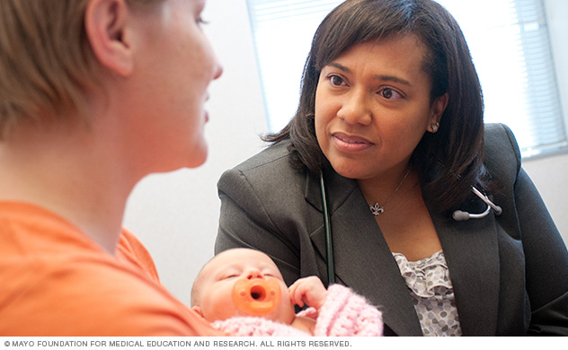 An obstetrics and gynecology specialist talks with a woman about her condition.