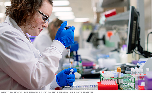 A lab worker processes samples in a test tube.