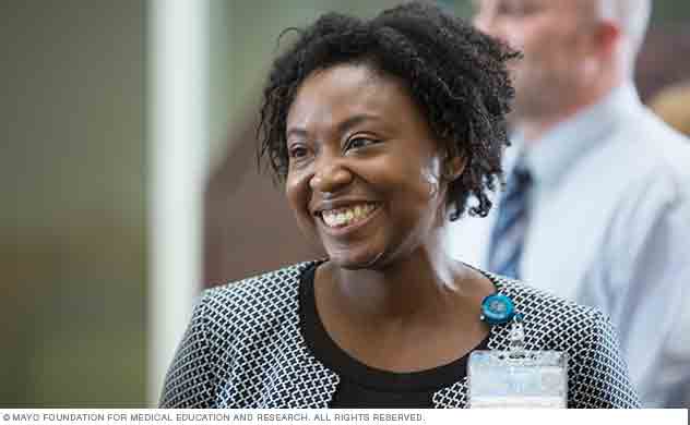 A Mayo Clinic physician smiles in conversation with a program participant.