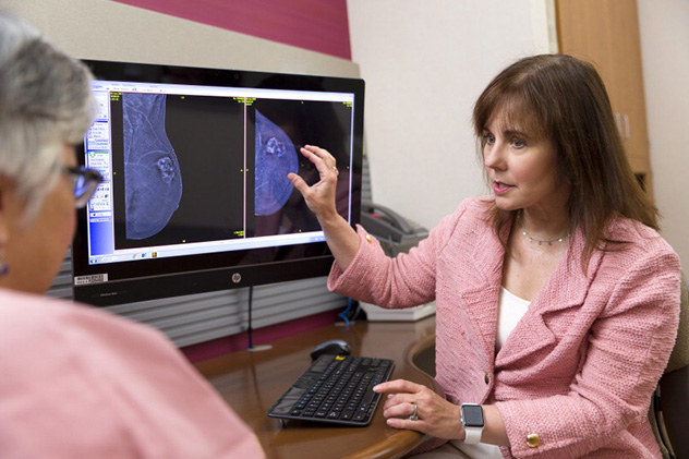 A Mayo Clinic surgical oncologist explains a condition to a patient.