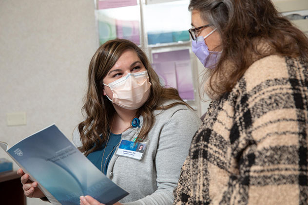 A Pancreas Clinic nurse speaks with a patient.