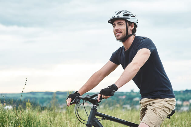 A man rides a bicycle.