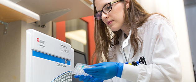 Michelle J. Cox conducting flow cytometry.