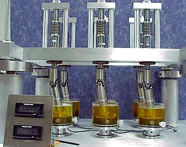 Custom-built wear test machine used for cyclic wear testing of articular joint implants at Mayo Clinic.