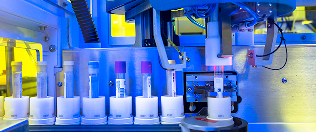 Photograph showing test tubes being processed in a machine