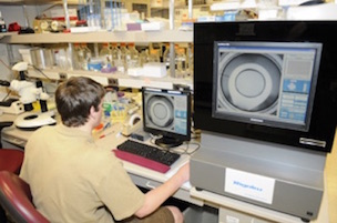 Investigator reviews protein crystallization trials using a robotic imaging system at Mayo Clinic's Structural Biology Facility in Minnesota.