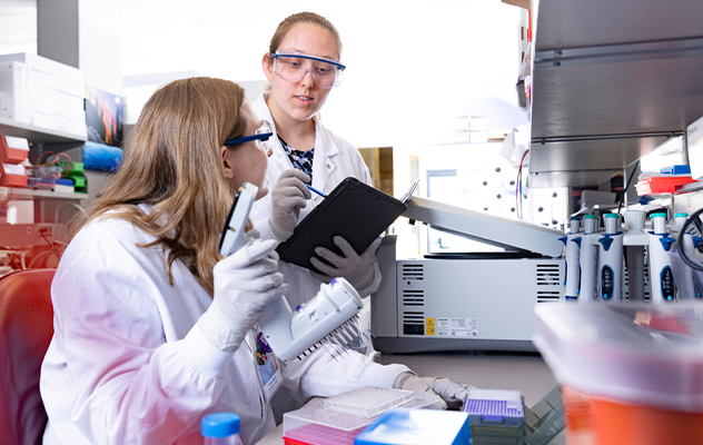 Photograph of a person with safety glasses working in a PKD research lab at Mayo Clinic