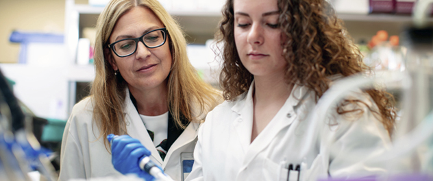 Dr. Karen Hedin supervises a laboratory trainee in the Department of Immunology at Mayo Clinic.