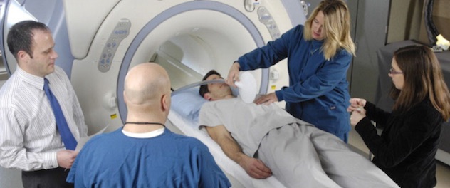 Staff members working with a research volunteer in Mayo Clinic's Magnetic Resonance Lab