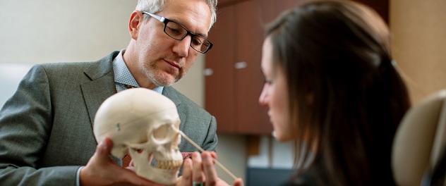 Facial plastic and reconstructive surgeon Dr. Grant Hamilton with patient