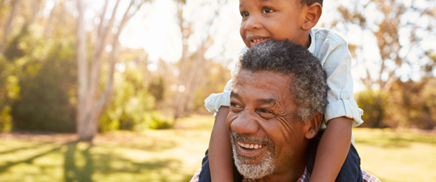 Older man carrying child