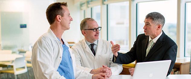 Three medical professionals in conversation