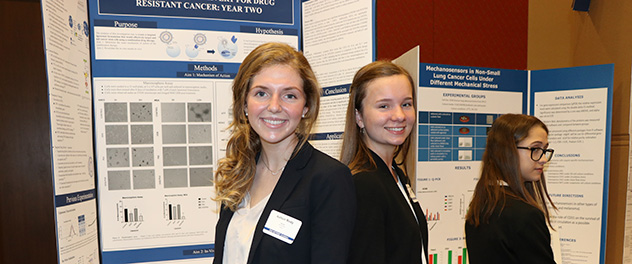 Three SPARK students at a science fair