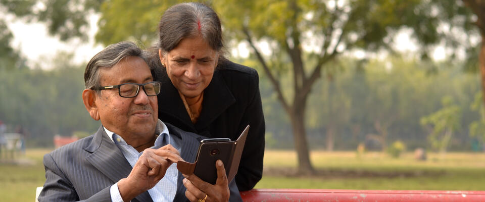 Image showing an older couple looking at a cell phone