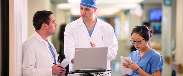 Physicians and nurse discussing a patient file