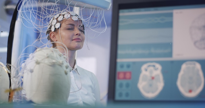 Head with electrodes attached with AI making scans.