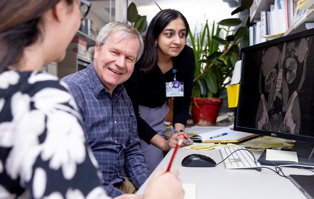  Photograph of Dr. Harris at Mayo Clinic working with PKD lab members